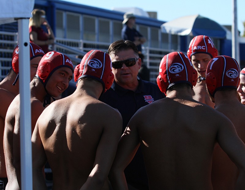 American River College coach Eric Black gathers the water polo team around as he breaks down Sierra’s defense. ARC fell to Sierra by a score of 4-3 on October 21, 2015. (Photo by Nicholas Corey)
