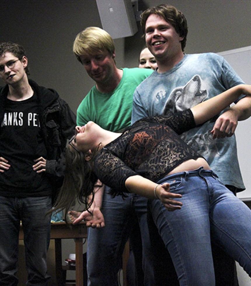 From left to right, Keanu Hoohuli, Zach Ekstedt, Spencer Murrish, Patrick Holland, and Mckayla Peterson acting out a skit where Peterson was an actor, Holland was a director and the other actors were his other personalities. Volunteers at the Improv club meeting on Thursday, Sept. 24 acted out skits like this and also participated in games from 10 p.m. to midnight on the American River College campus.  (Photo by Ashlynn Johnson)