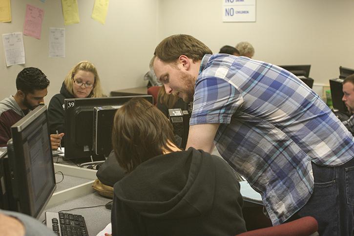 Mathematics assistant professor Matthew Register is helping a student at the Math Learning Center. Register worked at the MLC on October 28, 2015. (Photo by Mychael Jones)