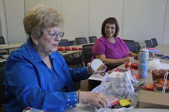 Sondra Fuson, left, and Ellen Read wrap items to be sold at the grab bag sale being put on by the American River College Patrons Club on Nov. 4 at 9 a.m. in the Student Center. (Photo by John Ferrannini)