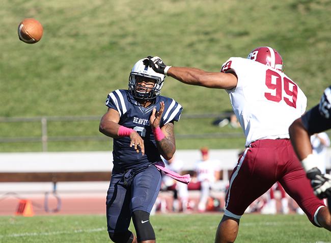 American River College quarterback Jihad Vercher passes under pressure during ARC football’s 47-22 win over rival Sierra College on Saturday, Oct. 31, 2015. (Photo by Barbara Harvey)