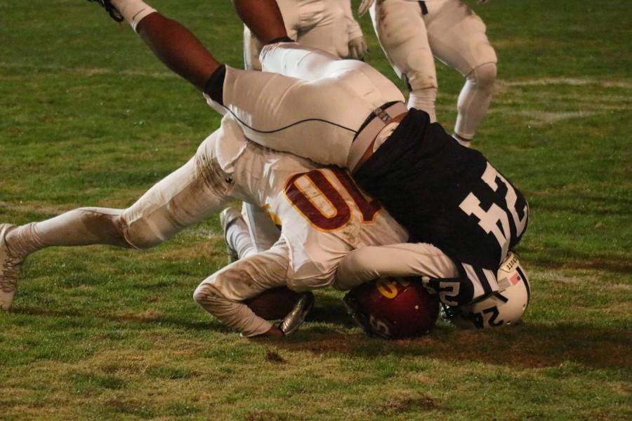 American River College defensive back Dmitri Scott tackles Sacramento City College wide receiver Keylan Mack during ARC’s 38-18 win over SCC on Saturday, Nov. 14, 2015. (Photo by Barbara Harvey)