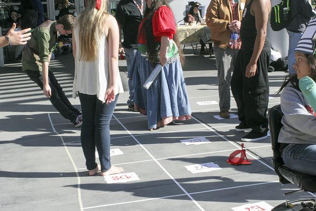 Clubs and Events Board President Justin Nicholson, left is seen falling down after his team the red team was defeated by the white team during a live chess game on Club Day. The game consisted of live human chess pieces played out on a created chess board outside the student center. (Photo by Mychael Jones)