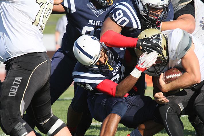 American River College defensive back Dmirti Scott and defensive lineman Nick Terry bring down the ball carrier from San Joaquin Delta College during the Gridiron Classic Bowl on Saturday, Nov. 21, 2015. Scott committed to Henderson State while Terry committed to the University of California Los Angeles (UCLA). (Photo by Barbara Harvey)