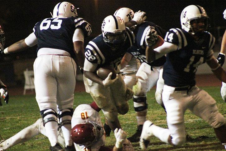 Running back Armand Shyne bursts through a wall of Sacramento City College defenders during ARCs 38-18 win. Shyne ran for two touchdowns with over 120 yards in the Nov. 14, 2015 win. (Photo by Nicholas Corey)