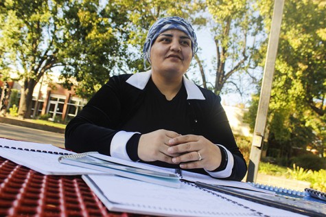 American River College student Mahjabeen Zazai sits with the lesson plans she used when she taught English in her native country of Afghanistan. Zazai graduated from high school in Afghanistan at the age of 15. (Photo by John Ferrannini)