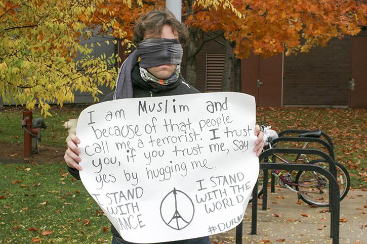 American River College student Burak Kocal holds a sign encouraging people to hug him. Kocal, a practicing Muslim, was protesting against the negative images widely associated with people of his faith. (Photo by Mychael Jones)