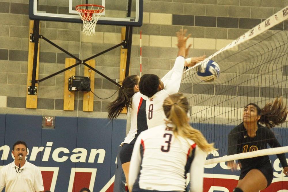 Sophomore middle blocker Erianna Williams, number 8, and freshman outside hitter Candice Reynoso, left of Williams, block a spike attempt by Hartnell sophomore Neysha Laumatia. ARC won 3-2 and also won their second match of the doubleheader against Lassen College. (Photo By Kameron Schmid)