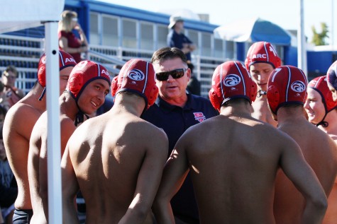 American River College coach Eric Black gathers the water polo team around as he breaks down Sierra’s defense. ARC fell to Sierra by a score of 4-3 on October 21, 2015. (Photo by Nicholas Corey)