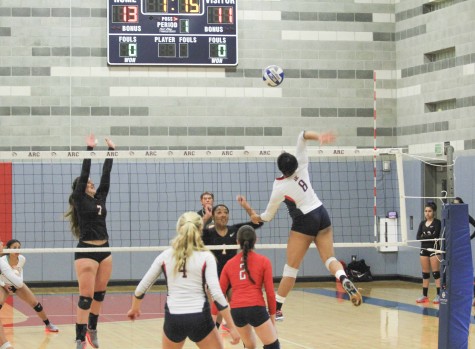 ARC player Erianna Williams gets up high to return the ball in a playoff win Tuesday night against City College of San Francisco at ARC. (Photo by Johnnie Heard)