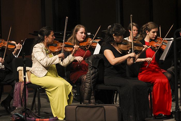 The violin section of the American River College orchestra performs a song for a winter concert. The concert was held on Dec. 2. (Photo by Michael Pacheco)