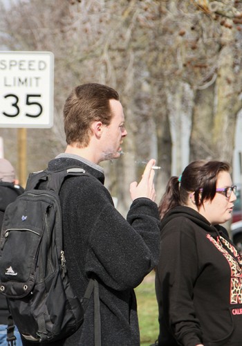 American River College students are forced to smoke at the bus stop, due to to new campus ban on smoking that went into effect on Jan. 1. (Photo By Kyle Elsasser)