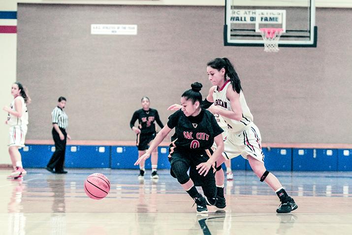 American River College guard Sariah Loudon  and Sacramento City College point guard Corina Tacardon fight for possession of the ball, during a game at ARC on Tuesday. ARC lost to Sac City 45-41. (Photo by Tyler M. Jackson)