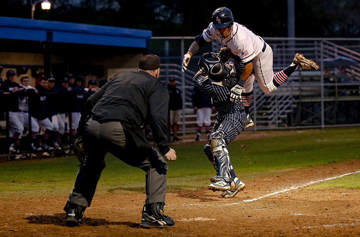 ARC outfielder Justin Jordan flies through the air while being tagged at home by the West Valley College catcher on Jan.28, 2016 at American River College in Sacramento Calif.The game was ARCs season opener, hosing West Valley College where ARC ended up losing 7-6. (Photo by Kyle Elsasser)