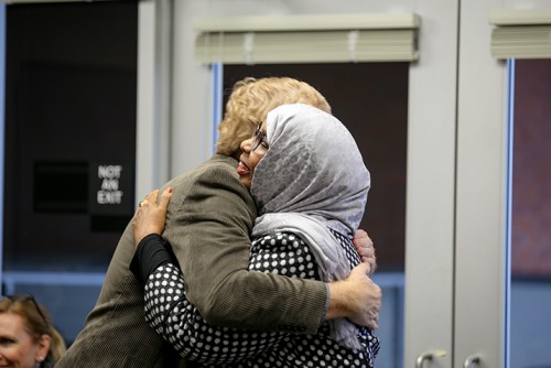 English professor John Hess (left) hugs former student turned teacher Faryal A. Said after Said received an award. Deserving teachers were presented with an award Thursday that was voted on by students at American River College. (Photo by Kyle Elsasser)