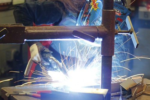 Liclond Electric technical sales engineer Miranda Frank welds together some metal during the Welding Expo held at American River on Feb.6, 2016. The welding industry is looking for weldiers and ARC, local unions and major companies came together to offer apprentaciships and other jobs to local welders. (Photo by Matthew Nobert)