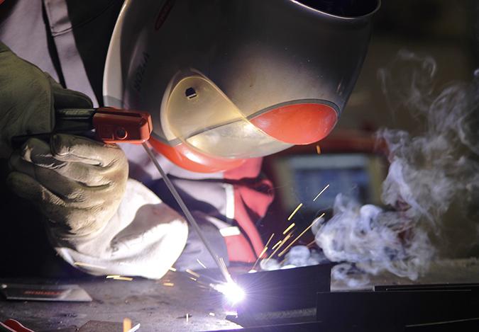 Fronius technical sales engineer Fritz Arumber welds together some metal during the Welding Expo at American River College on Feb.6, 2016. The welding industry has been looking for welders and the expo was held to offer apprenticeships and jobs. (Photo by Matthew Nobert) 