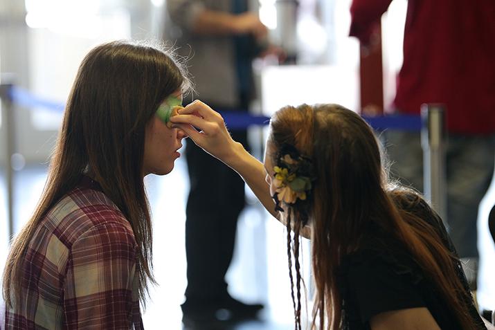 Makeup artists paint the faces of audience members before seeing American River College students perform in the production Gumbo. Gumbo is a theatrical variety show with a theme of Aging. Performed on Feb. 6 2016. (Photo by Kyle Elsasser)