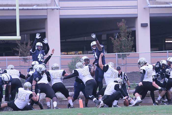 Former American River College football player Antonio Perez (54), seen airborne to the right attempting to block a kick during the 2014 season, died yesterday due to an unverified cause.
(File Photo)