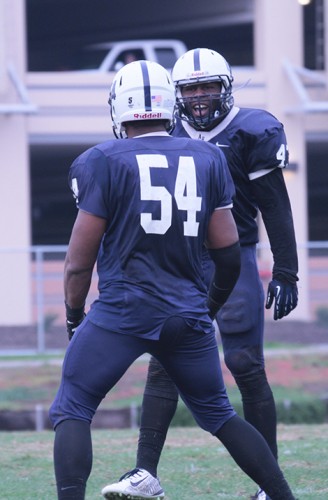 Former American River College football player Antonio Perez (54), seen celebrating with teammate Lawrence Hall during 2014, 