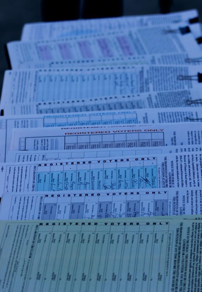 A table outside the ARC library has multiple petitions. Students may not know what theyre signing on to.(Photo by Matthew Nobert)