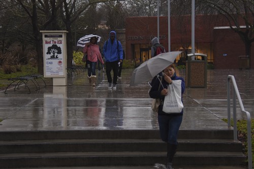 Returning Student find a rainy day to greet them as they make their way to Student Services. This years El Nino will help with the drought in California but it wont solve it. (PhotoTracy Mapes)