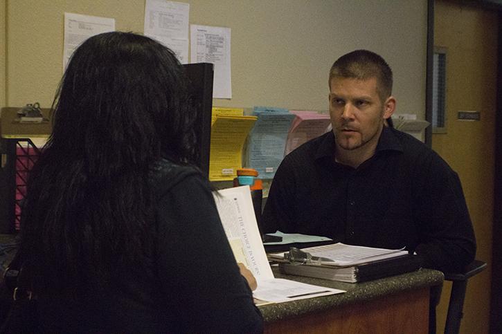 Joe Rust, right, talks with a student in the transfer center on Tuesday, March 1, 2016. Rust is also a full-time counselor for the college. (Photo by Allante Morris)