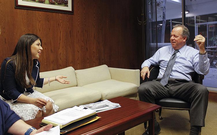 American River College representative Eugenia Torres (left) speaks with California State Assemblyman Bill Dodd in his office at the capitol in Sacramento, California on Monday, Feb. 29, 2016. The delegation from ARC lobbied for a bill that would fund mental health services at public California colleges. (Photo by Hannah Darden)