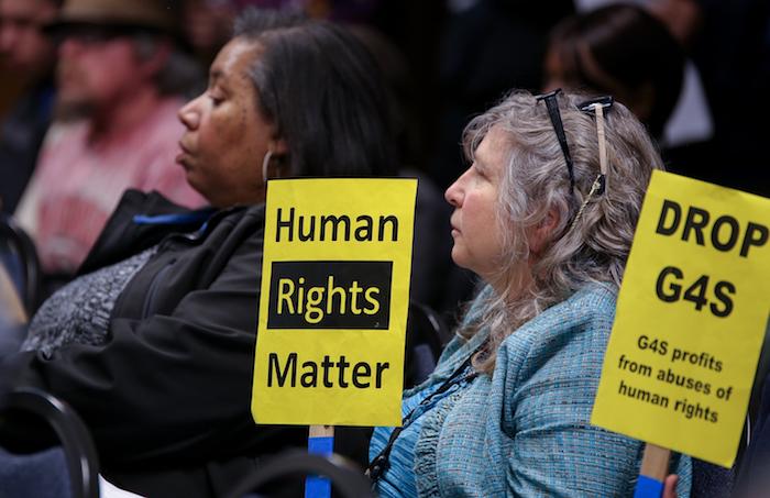 American River College senator Laurie Jones holds up a sign that reads Human Rights Matter during a Sacramento Regional Transit board meeting Monday. The RT board approved a 10% fare increase for July 2016. (Photo by Kyle Elsasser)