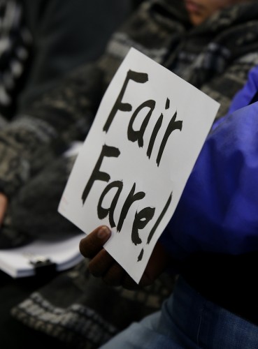 An audience member holds up a sign that reads 'Fair Fare!' during the Sacramento Regional Transit board meeting Monday. Several protesters attended the meeting. (Photo by Kyle Elsasser)