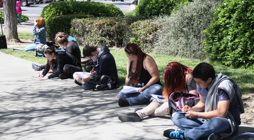 Proffesor Paula Rodriguez-Rutten's math 103 class takes a test outside due to a fire alarm on March 29, 2016 at American River College in Sacramento, California. The alarm was sounded because a steak that was being cooked in a toaster oven in Liberal Arts 152 Staff started smoking. (Photo by Matthew Nobert)