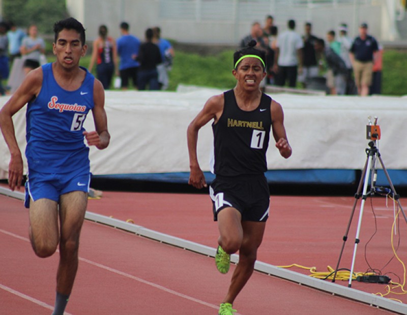 Adam Gonzalez of Sequoias (left) chases down Jorge Sanchez of Hartnell College (right) before the finish line of the men’s 5000m race at the American River Invitational on March 26, 2016 at American River College. Gonzalez won the race with a time of 15:36.18, beating Sanchez by 57 hundreths of a second. (Photo by Mack Ervin III)