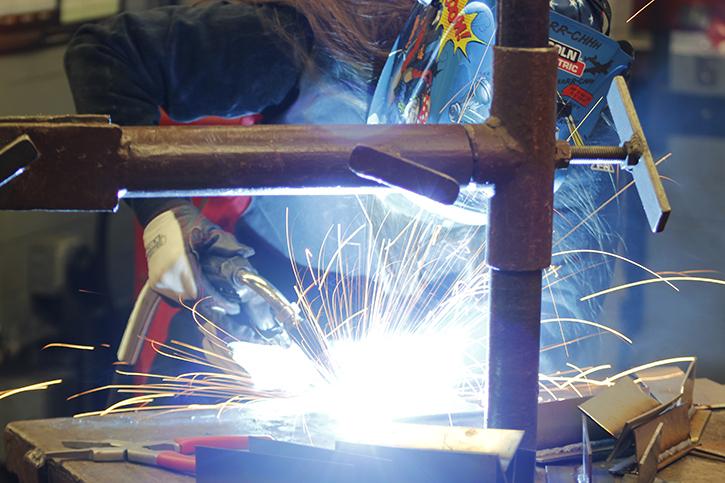 Liclond Electric technical sales engineer Miranda Frank welds together metal during a Welding Expo held at American River College in February. ARCs welding technology program is one of the 55 from the campus that showed an increase in student income. (Photo by Matthew Nobert)