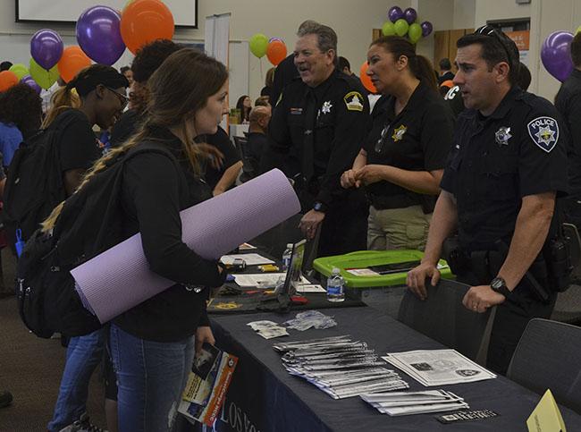 The Los Rios Police Department speaks with students during the career fair at American River College on April 7.  (Photo by Sharriyona Platt)