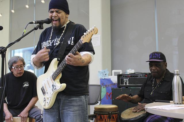 James Estrella plays an original song with Eric Chun and Ron Carson backing him up with percussion during the Acoustic cafe held at American River College on April 1, 2016. Acoustic cafe is hosted by Eric Chun. (Photo by Robert Hansen)