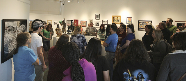 A group of students, staff, faculty and community members gather at the student art show at the James Kaneko Gallery at American River College in Sacramento, California on April 26. The show runs from April 25 to May 11. (Photo by Hannah Darden)
