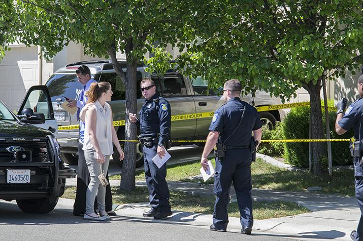 Police talk to local residents at the site of a shooting in Natomas on April 18, 2016.The shooting injured one man and caused the lockdown of nearby Merryhill Preschool. (Photo by Joe Padilla) 