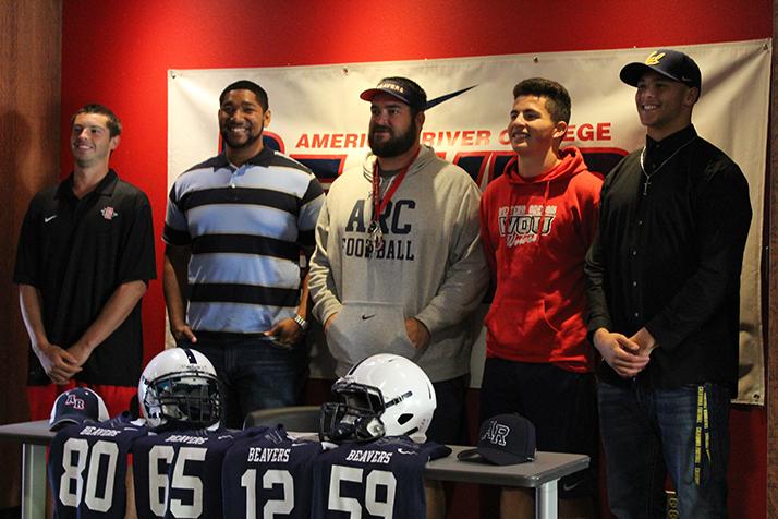 From left to right: wide receiver Marc Ellis, offensive lineman Max Harrison, head coach Jon Osterhout, wide receiver Jonathan Lopez, and linebacker Jordan Kunaszyk pose for a picture during a signing day event on April 1, 2016 at American River College. The four players committed to four-year universities following the 2015 season. (Photo by Mack Ervin III)