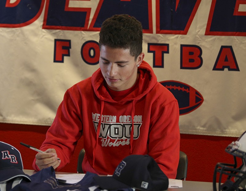 Jonathan Lopez signs his letter of intent to play football at Western Oregon on April 1 2016 at American River College. Lopez caught 36 passes for 540 yards and 6 touchdowns for the beavers in 2015. (Photo by Kyle Elsasser)
