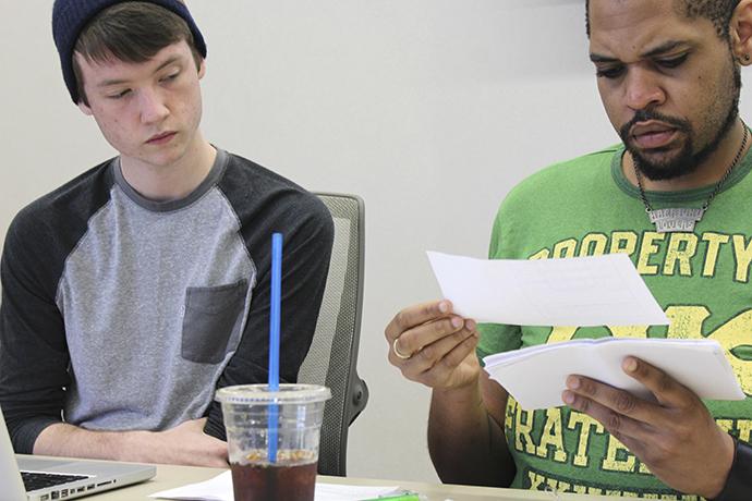 CAEB President Justin Nicholson (left) and Director of Finance Jeremy Diefenbacher (left) review the results of the survey at the the Senate meeting on April 7, 2016.  (Photo by Robert Hansen) 