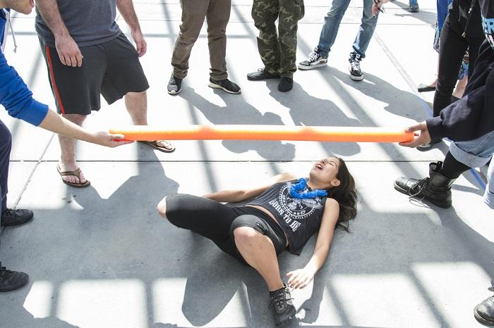 American River College student Angelica DeGuzman went low during the limbo competition at Club day near the book store on April 14, 2016. Club day rules allows the person to touch the ground as long as their hands dont touch the ground. (Photo by Joe Padilla)