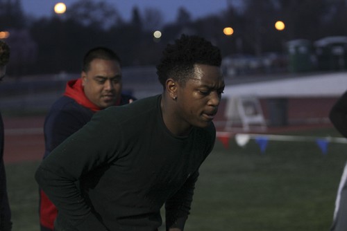 Defensive back Sammy Gray participates in a drill during an off-season conditioning class while linebacker coach Sid Robertson looks on. Robertson, along with all the assistant coaches, volunteers his time during the off-season. (Photo by Matthew Peirson)