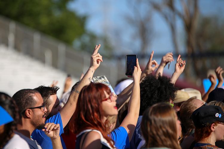 A member of the audience holds up a peace sign while waiting for presidential candidate Bernie Sanders to begin his rally at Bonney Field in Sacramento, California on May 9, 2016. (Photo by Kyle Elsasser)