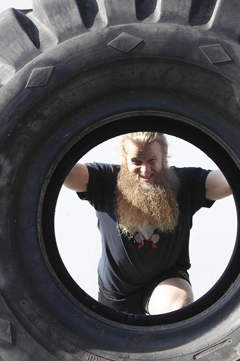 Allan Thrall flips a tire that weighs 440 pounds. Thrall is the owner of Untamed Strength, a gym that specializes in strongman training.  (Photo by Bailey Carpenter)