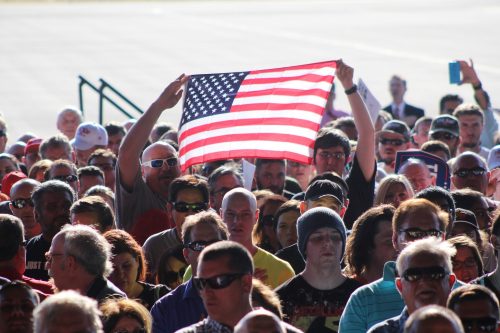 Supporters of Donald Trump hold up an American flag during the recital of the pledge of allegiance at a campaign event in Sacramento, California on June 1, 2016. Trump's first visit to the California capital drew nearly 5,000 supporters. (Photo by Mack Ervin III)