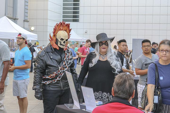 Two cosplayers visit one of the many booths at Artmix at the Crocker Art Museum in Sacramento, California on Sept. 8 (Photo by Luis Gael Jimenez)