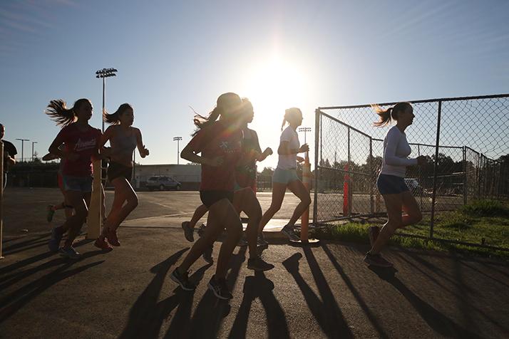 The American River College womens cross country team warm up in the parking lot behind the new soccer stadium before their first meet of the season at Sierra College on Sep. 2. (Photo by Cheyenne Drury)