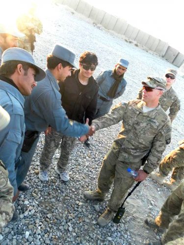 Qais Ahmad (center) translates for first lieutenant Spinelli (right) of the 327th Alpha Company and Afghan Police (left) after a combat and manevaor training in Fob Connolly. (courtesy of Qais Ahmad)