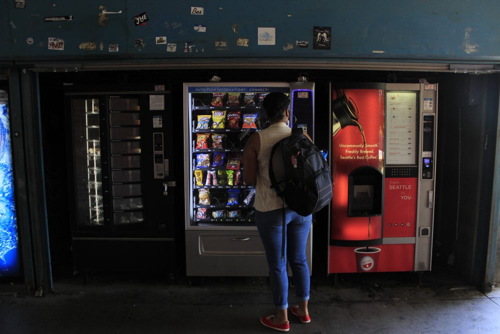 A student passes by a bank if vending machines on ARCs campus on September 12, 2016. (Photo by Jared Smith)