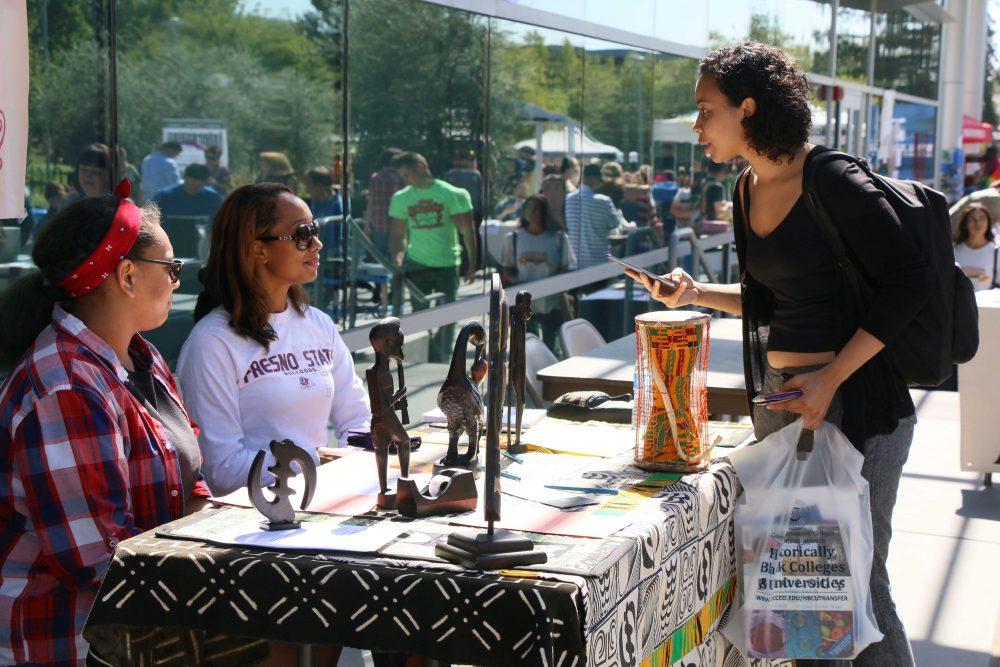 Student Tasiya Owens speaks to Umoja-Sakhu learning community member Nia Simien and counselor Reyna Moore during Club Day at ARC. Sept. 22. (Photo by Laodicea Broadway)